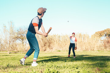 Young couple playing baseball in park