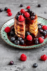 Pancakes with blueberries, raspberries and black currant sirup