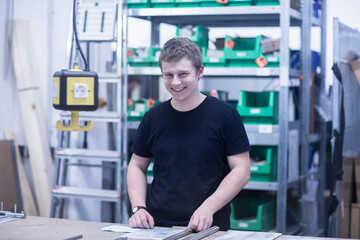 Portrait of man in a factory holding steel