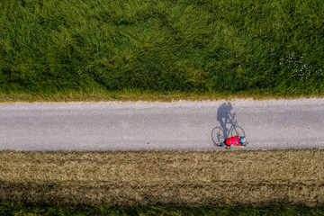 Triathlete riding bicycle on country road, Germany