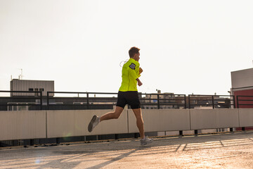 Young man running on parking level