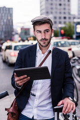 Young man in the city with tablet