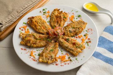 Tapa of anchovies battered with flour and egg in a Spanish restaurant. Traditional tapa of Spanish gastronomy.