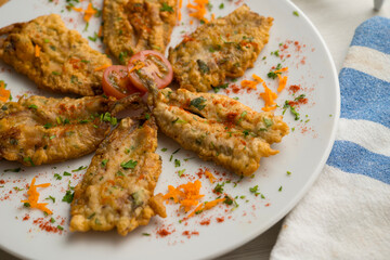 Tapa of anchovies battered with flour and egg in a Spanish restaurant. Traditional tapa of Spanish...