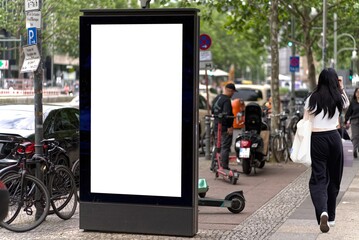 Empty white billboard portrait format on the street.