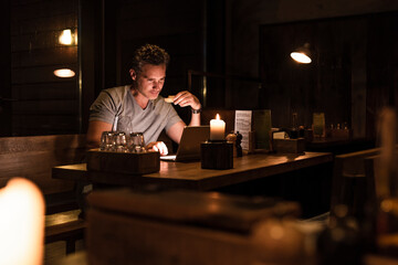 Man having dinner looking at laptop