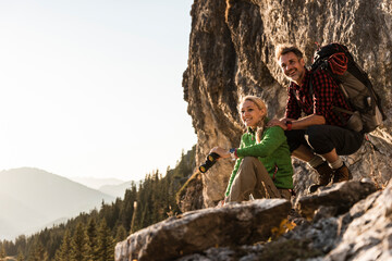 Couple taking a break in the mountains, looking at view