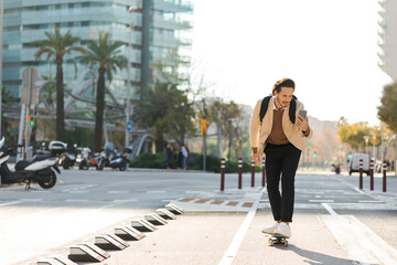 Man looking at cell phone while skateboarding in the city