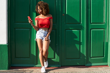 Woman in red checking her phone