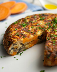 Spanish omelette with sweet potato, onion and egg. Traditional tapa of Spanish gastronomy.