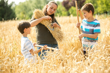 Children helping to harvest wheat