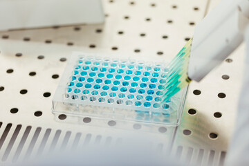 Close-up of pipetting in lab