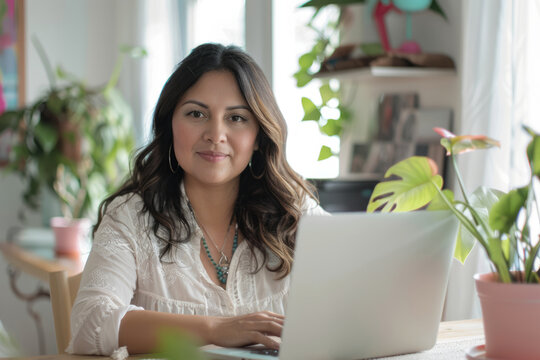 a Hispanic woman managing a home-based event planning business, organizing details on a laptop
