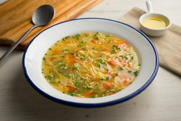 Noodle soup with vegetables. Traditional recipe of Spanish gastronomy.