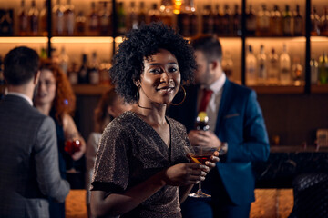Portrait of a young woman having a cocktail in a bar