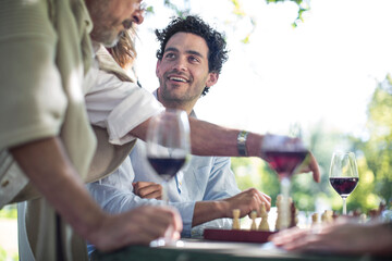 People gathering around chess board