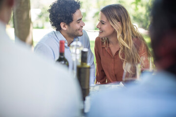 Couple sharing spaghetti at outdoor table