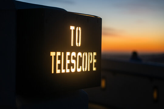 glowing sign with and sunset background