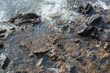 Dark rocks on a beach.