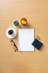 Domestic daily table top objects with coffee cup, purse and blank open page note book still life...
