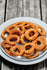 deep fried crispy onion rings on grey plate