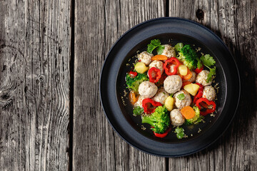 chicken meatball soup with vegetables in a bowl