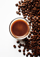 Glass of coffee with coffee beans scattered on isolated white background. Top view with copy space. Menu or drinks design concept.