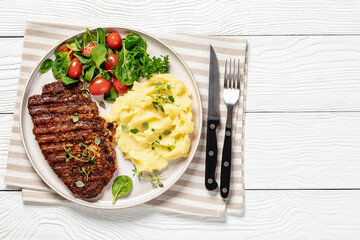 grilled pork steak with mashed potato and salad