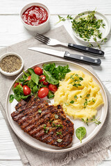 grilled pork steak with mashed potato and salad
