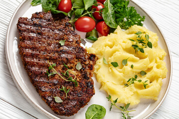 grilled pork steak with mashed potato and salad