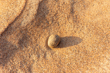Small stones on the sand in the desert in Dubai, UAE.