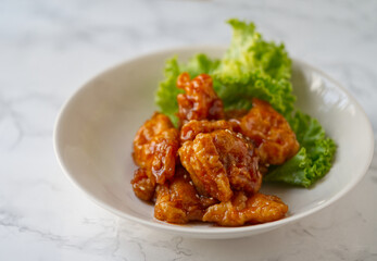 Close up delicious Chinese food menu, Three flavors pork tenderloin. The Chinese menu dish in on a white marble table with natural light.