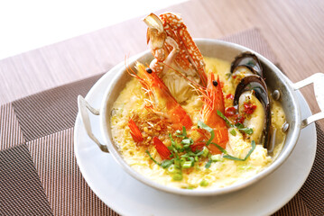 Asian healthy menu, streamed egg with seafood. Close up streamed egg in a small handle bowl with natural light.