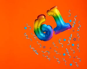 Multicolor balloon number 61 - Confetti explosion on orange background. Birthday card