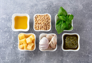 Traditional Italian pesto recipe on a grey stone background.