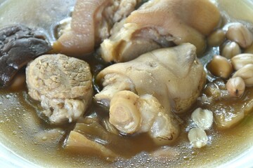 boiled pork knuckle with peanut and ginger with mushroom soup on plate