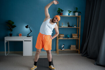 Millennial man bending aside, doing exercises at home. Sportsman having domestic training, working...