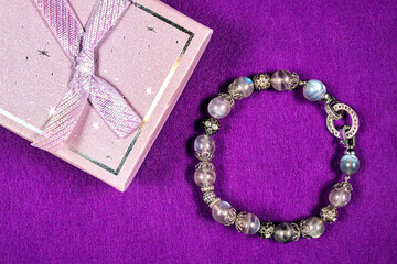 A beautiful bracelet made of natural stones and an elegant box for it.