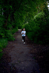 Obraz premium the little girl is running around the park