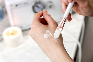 a heart made of white cream painted on a woman's hand