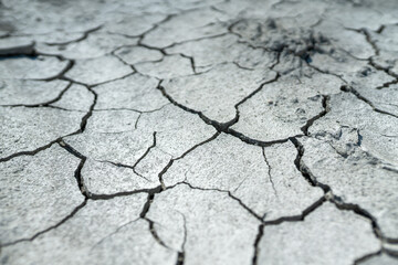 Dried-up lake in mountainous area due to an environmental problem. Cracked soil due to global warming