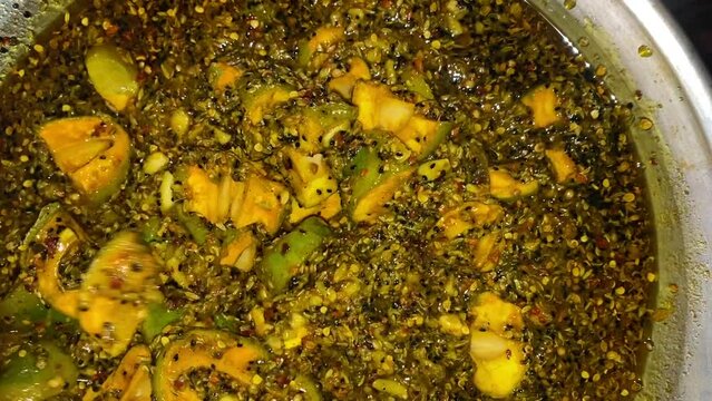mango pickle mixing in spices . mango pickle. spicy. yummy