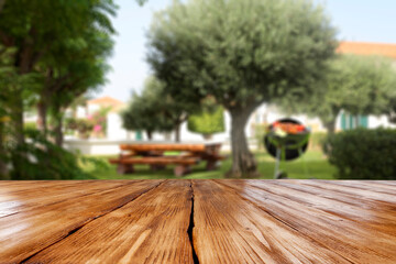 Wooden desk of free space and grill party in garden 