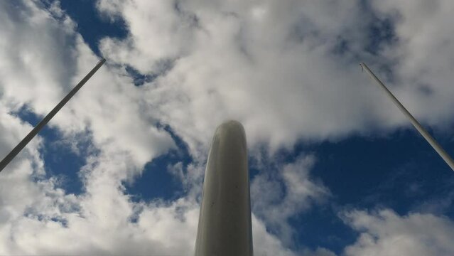 American Football Field Goal Posts against a cloudy blue sky. Upright metal posts form the goal through which a kicker kicks a football for extra point. 