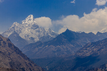 Ama Dablam mountain summit peak in Himalaya mountain range, Nepal. Beautiful high altitude mountain landscape with clouds in spring at the Everest Base camp trekking region. Hike in Himalaya