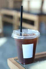 plastic cup of iced coffee with straw