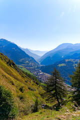 Fototapeta premium Scenic view of mountain village Airolo with Leventina Valley in the Swiss Alps on a sunny late summer day. Photo taken September 10th, 2023, Gotthard, Canton Ticino, Switzerland.
