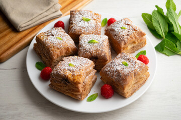Miguelitos are typical pastries from Spain made from puff pastry, filled with chocolate cream and sprinkled with sugar.