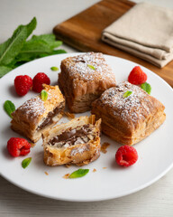 Miguelitos are typical pastries from Spain made from puff pastry, filled with chocolate cream and sprinkled with sugar.