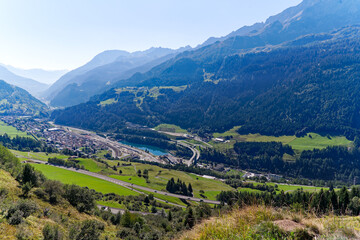 Obraz premium Scenic aerial view of mountain village Airolo with Leventina Valley in the Swiss Alps on a sunny late summer day. Photo taken September 10th, 2023, Gotthard, Canton Ticino, Switzerland.